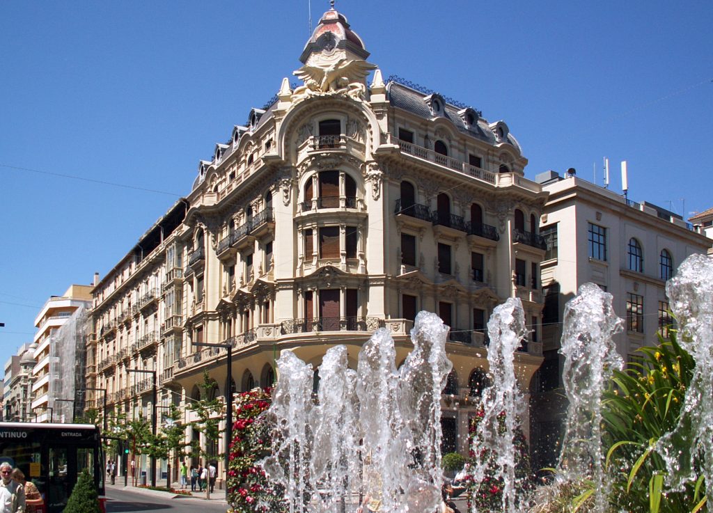 Street in central Granada with elegant architecture and fountains