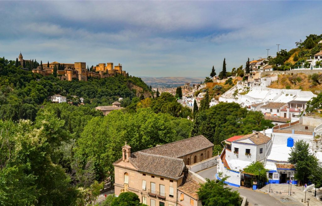 Panoramic view of Sacromonte with cave houses and the Alhambra palace in Granada