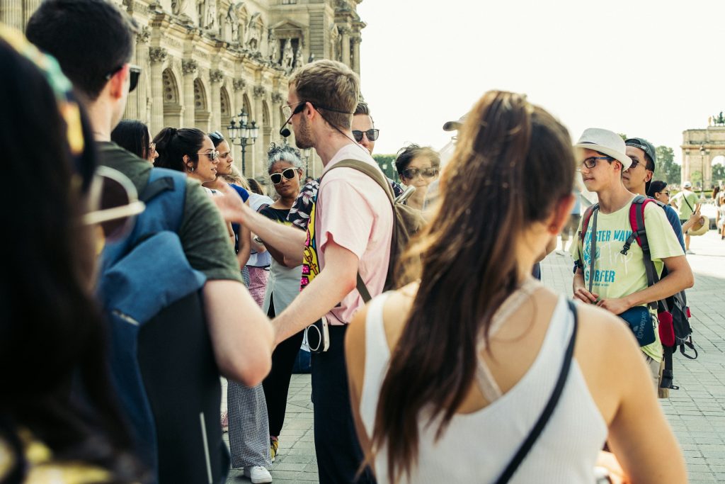 Tour guide speaking to group of visitors outdoors